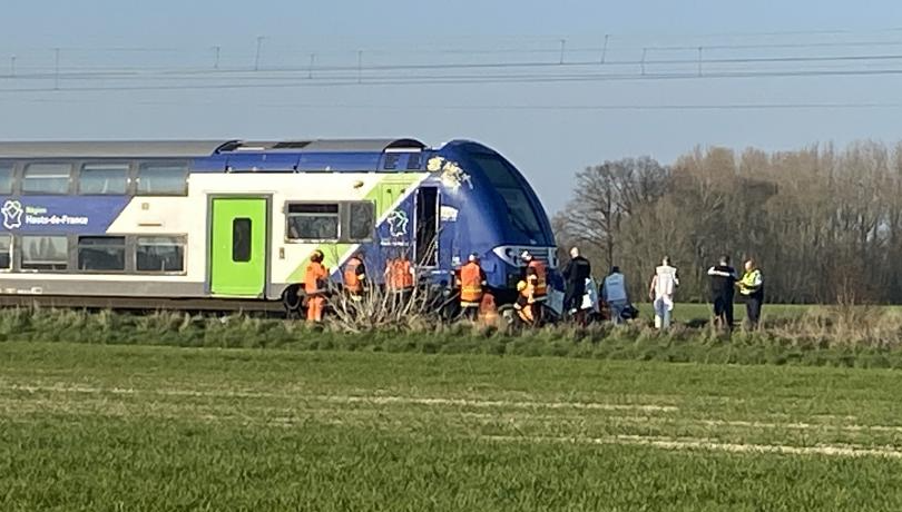 One Dead After Train and Car Collision in Nomain, France A fatal collision between a regional train and a car occurred Thursday afternoon in Nomain, leaving one person dead. The accident happened shortly after 4 p.m. on the Lille–Valenciennes rail line at a level crossing on Rue du Chapitre, near Orchies. Emergency responders, including firefighters, were quickly dispatched to the scene. According to initial reports, the vehicle became lodged beneath the front of a regional express train (TER), requiring specialized lifting and extrication equipment to remove it. Authorities say the victim, believed to be the driver of the car, was a 53-year-old man from Auchy-lez-Orchies. He was pronounced dead at the scene. A dog that was in the vehicle also reportedly died in the crash. Preliminary findings suggest the driver may have crossed the tracks while the crossing barriers were already down. The incident led to a suspension of train services in both directions along the line as investigations and recovery efforts continue.